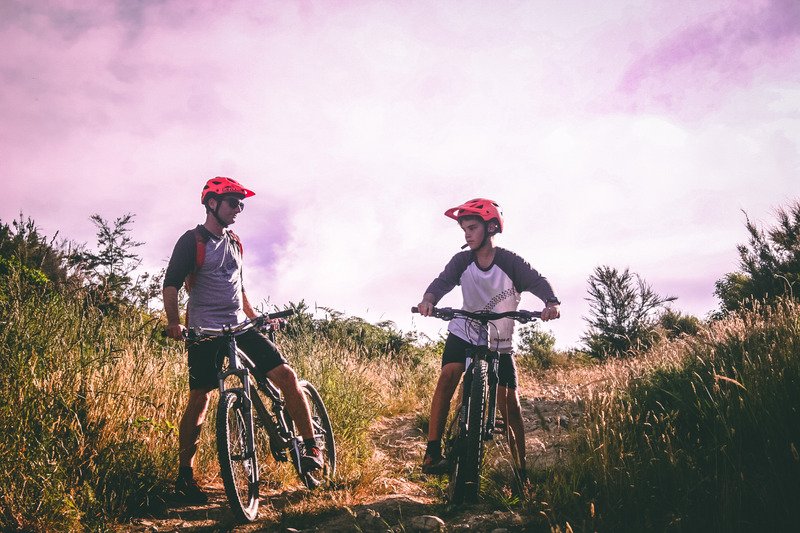 Canva - Two Man Riding Mountain Bike on Dirt Road at Daytime (1)