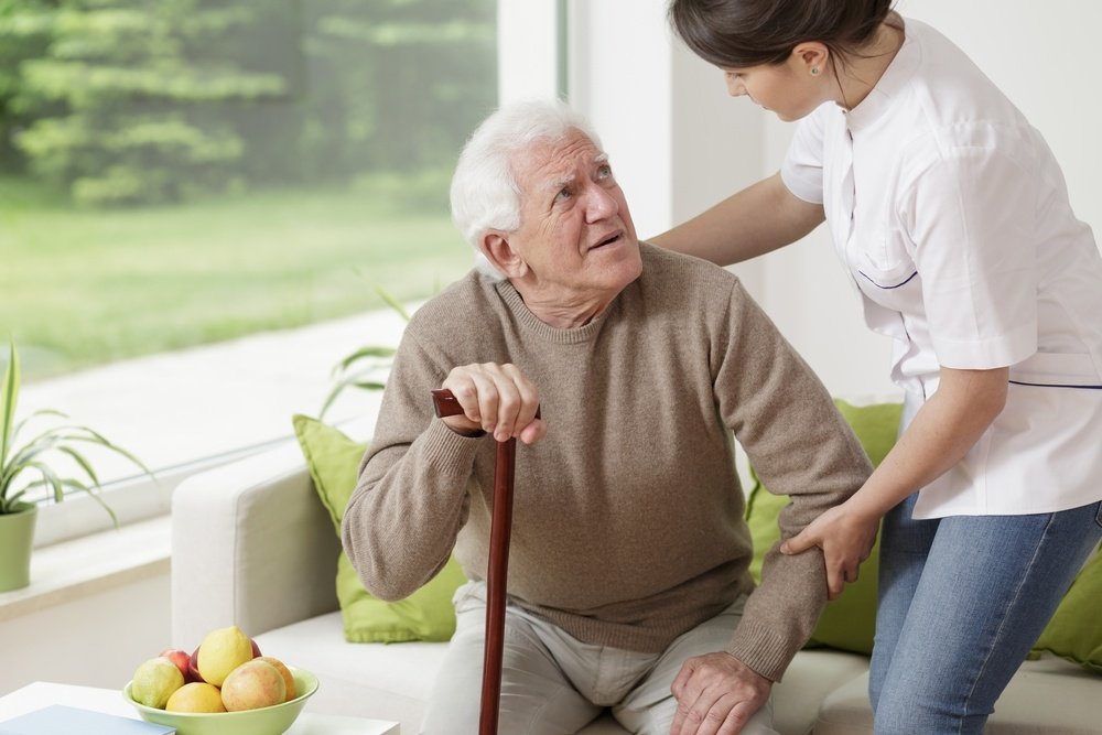 Young woman helping old man to stand up.jpeg