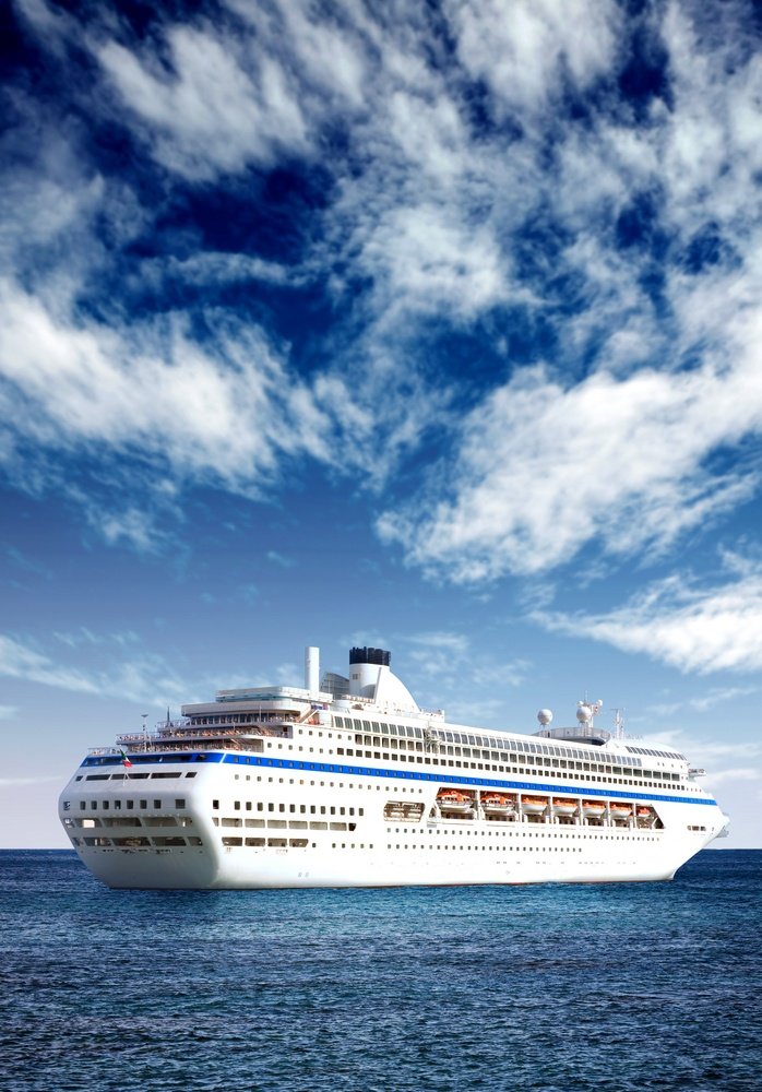 cruise liner in open sea with a beautiful blue sky behind it